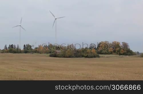 Two wind turbines in the field. Green energy.