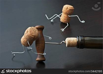 two wine corks and bottle with corkscrew