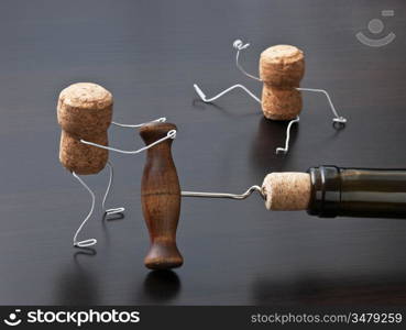 two wine corks and bottle with corkscrew