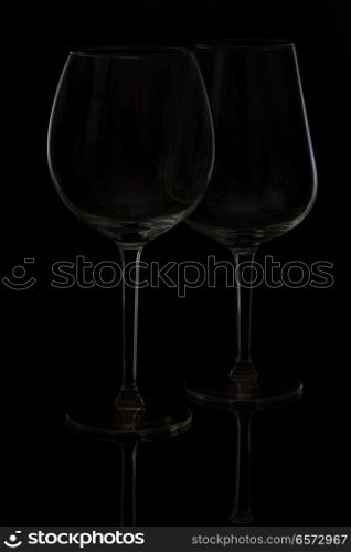 Two wine glasses on black background. Wine glasses on black