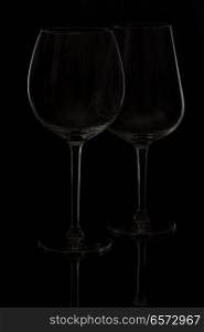 Two wine glasses on black background. Wine glasses on black