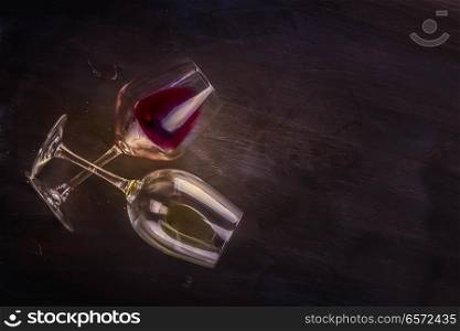 Two wine glasses on table, top view scene with copy space toned image. Glass of red wine