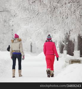 two winter women run by snow frosted alley