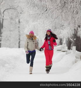 two winter women run by snow frosted alley