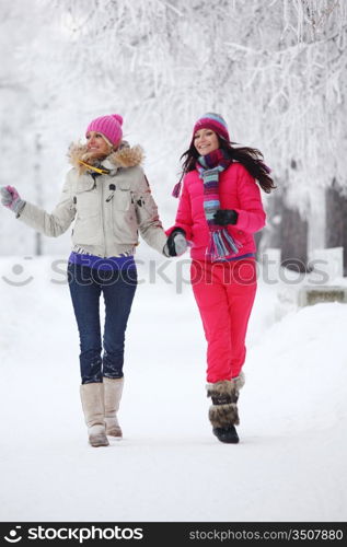 two winter women run by snow frosted alley