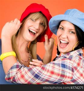 Two woman friends young wear funny hats smiling crazy outfit