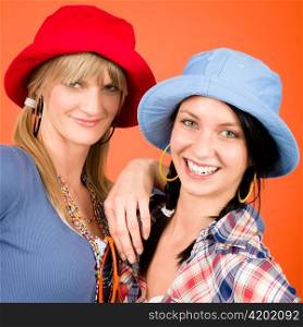 Two woman friends young wear funny hats smiling crazy outfit