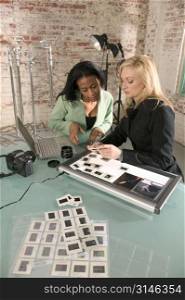 Two Woman Looking at Slides