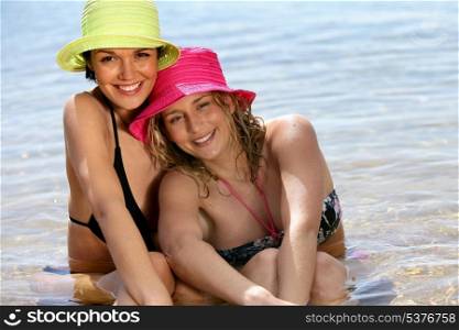 Two woman sitting in the sea