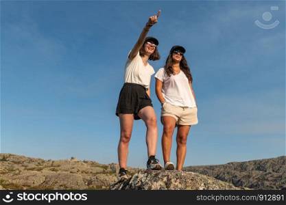 Two woman traveler watching sunset direction on mountain landscape.