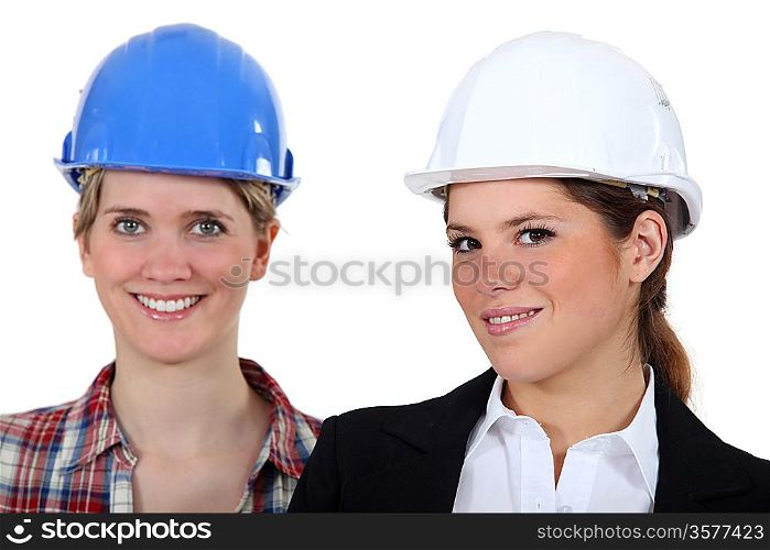Two woman with their hardhat on.