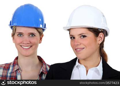 Two woman with their hardhat on.
