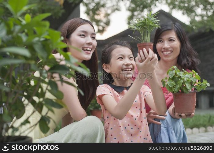 Two Women and Young Girl Gardening