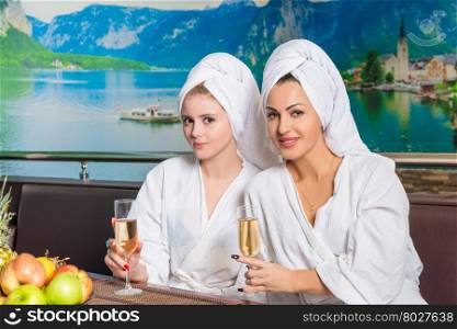 Two women at a table with glasses of champagne