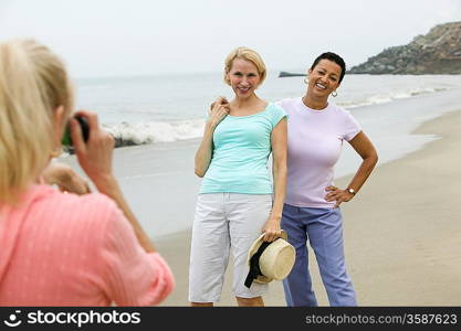 Two women being photographed on beach