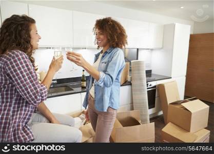 Two Women Celebrating Moving Into New Home With Champagne