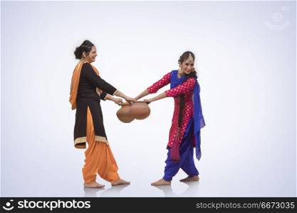 Two Women Dancing with Earthen Pot