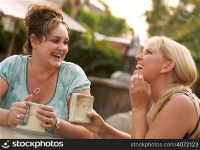 Two women drinking and talking in garden