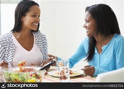 Two Women Eating Meal Together At Home