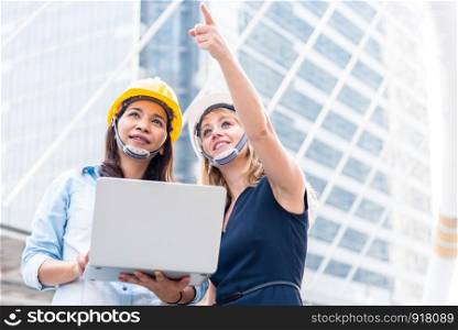 Two women engineering surveying for startup and launching new project. Building and construction concept. Business and happiness of cooperation concept. Civil engineer theme. City and urban theme