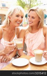 Two Women Enjoying Cup Of Coffee In CafZ