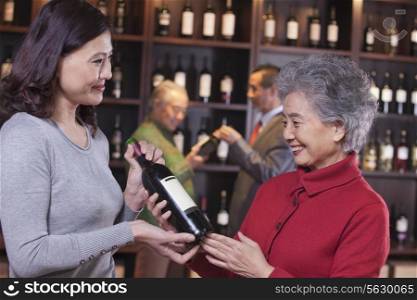 Two Women Examining Wine at a Wine Store