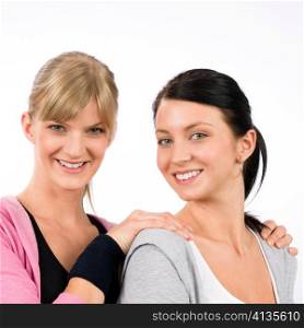 Two women friends sport outfit hugging smiling isolated portrait