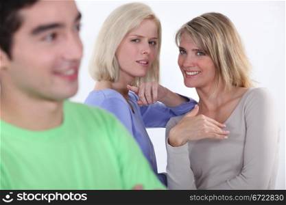 Two women gossiping about man