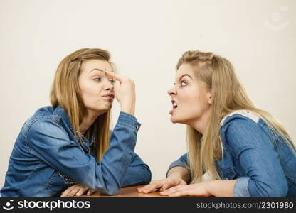 Two women having argue mocking up being mad at each other. Female telling off, ignorance concept.. Two women having argue fight