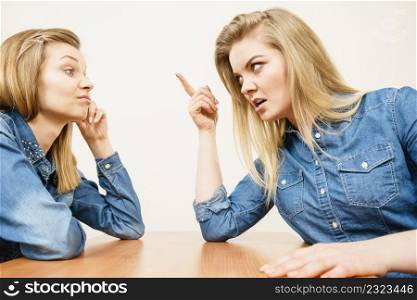 Two women having argue mocking up being mad at each other. Female telling off, ignorance concept.. Two women having argue fight
