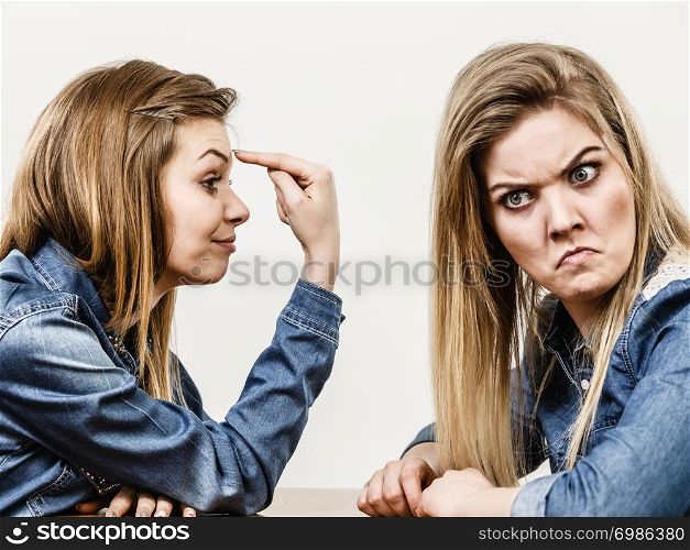 Two women having argue mocking up being mad at each other. Female telling off, ignorance concept.. Two women having argue