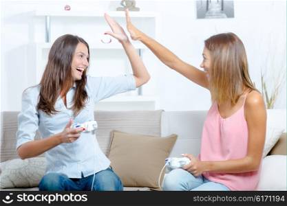 Two women having fun playing video games