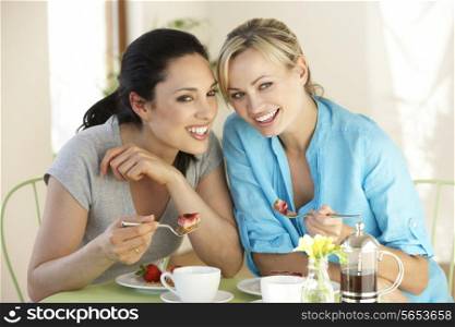Two Women Having Snack In Cafe