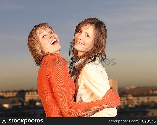 Two women hugging, laughing