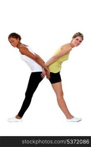 Two women in gym clothing forming the letter X