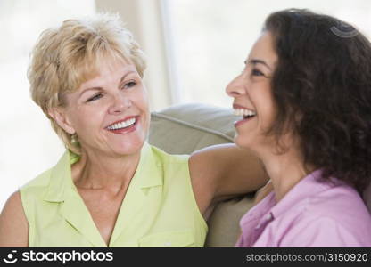 Two women in living room talking and smiling