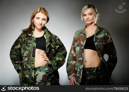 Two women in military clothes army girls on gray background