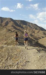 Two women jogging in mountains