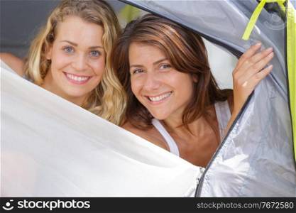 two women lying in tent at campsite