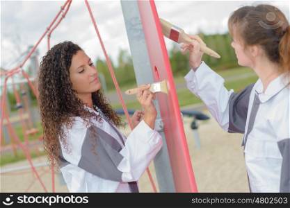 two women painting outdoors