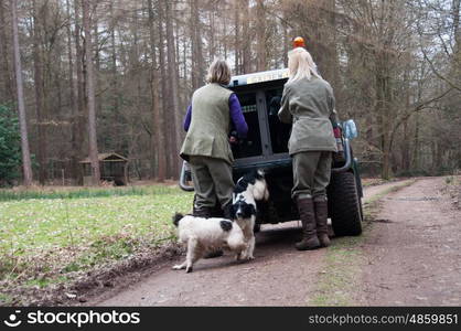 Two women putting dogs into a car after shooting