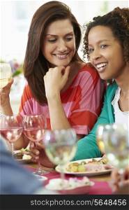 Two Women Relaxing At Dinner Party