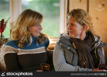 Two women relaxing in a converted barn