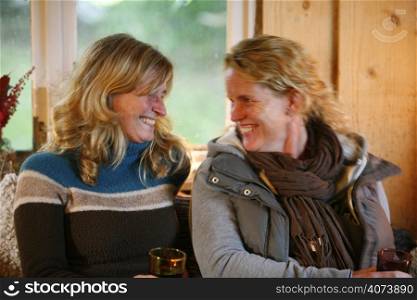 Two women relaxing in a converted barn
