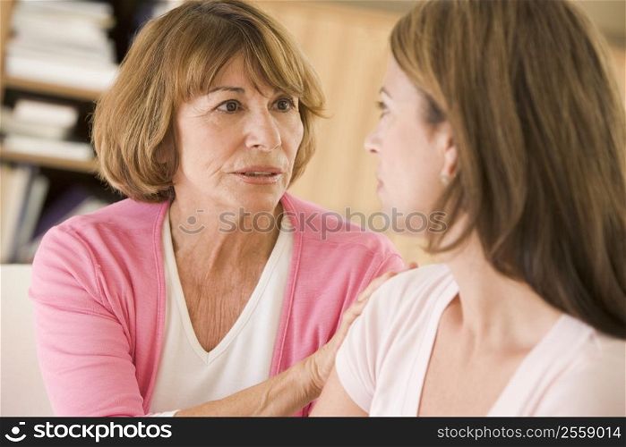 Two women sitting in living room talking