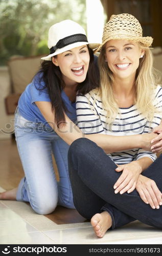 Two Women Sitting Outside House