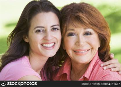 Two women standing outdoors smiling