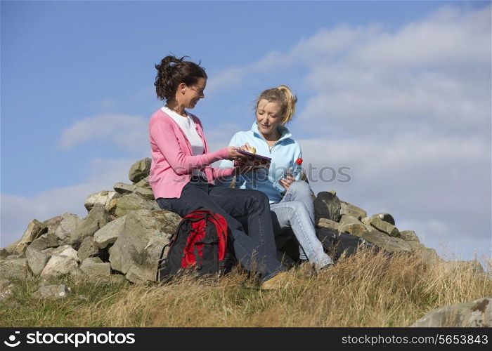 Two Women Stopping For Lunch On Countryside Walk