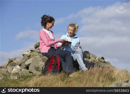 Two Women Stopping For Lunch On Countryside Walk