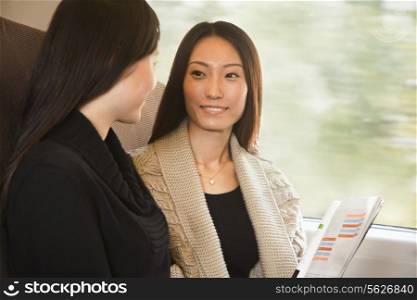 Two Women Talking on a Train